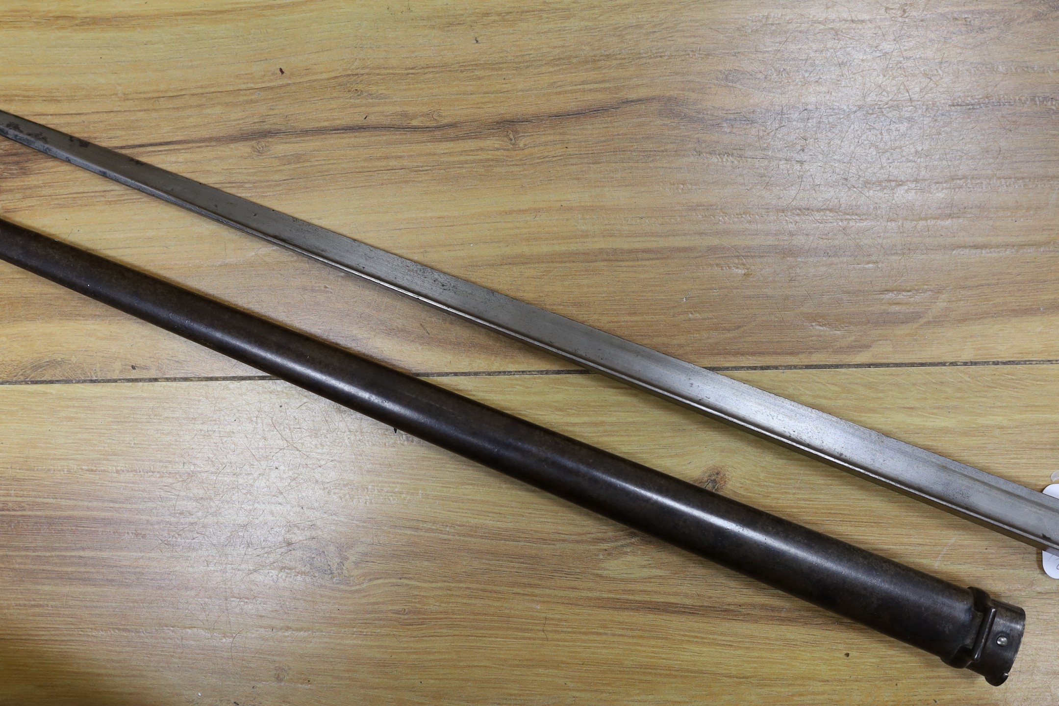 A Victorian officer's sword, lacking sheath, together with a 19th century French ’1877’ bayonet and sheath